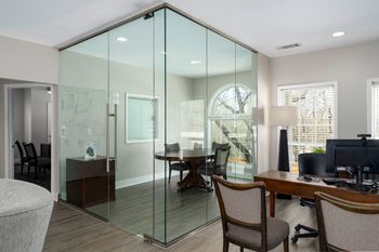Leasing office desk is adjacent to a conference room.